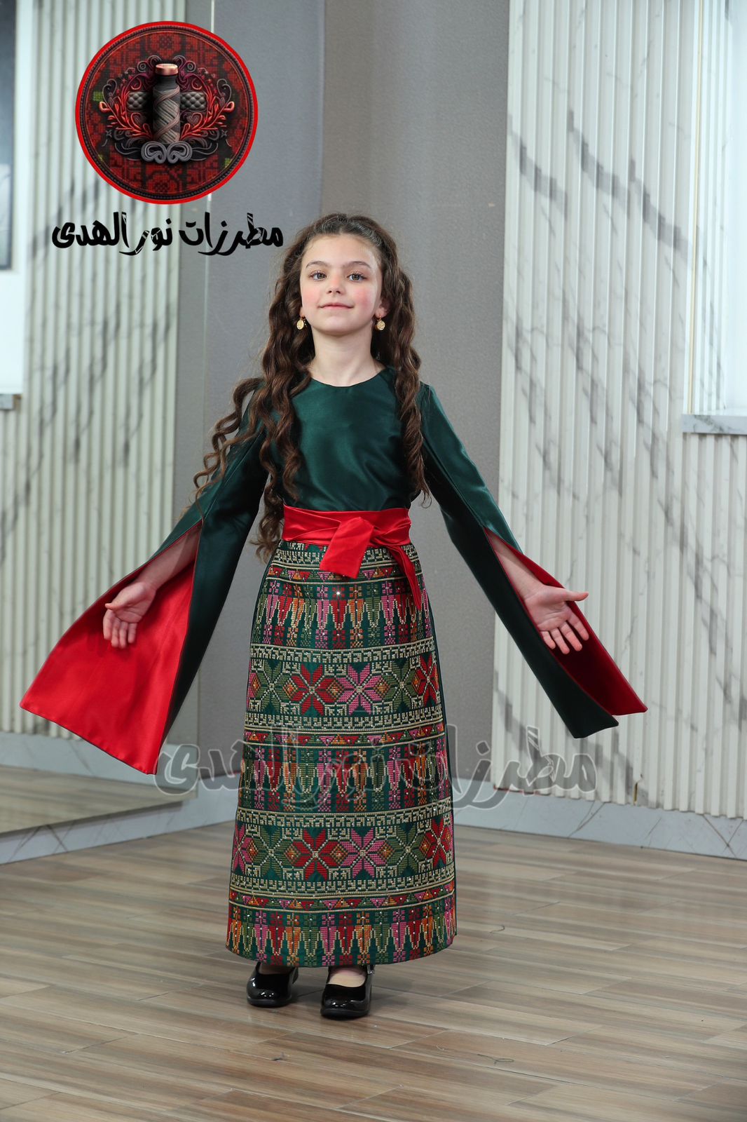 Olive green girls Oriental embroidered satin heritage dress with red waist sash and colorful Tatreez-inspired skirt panel