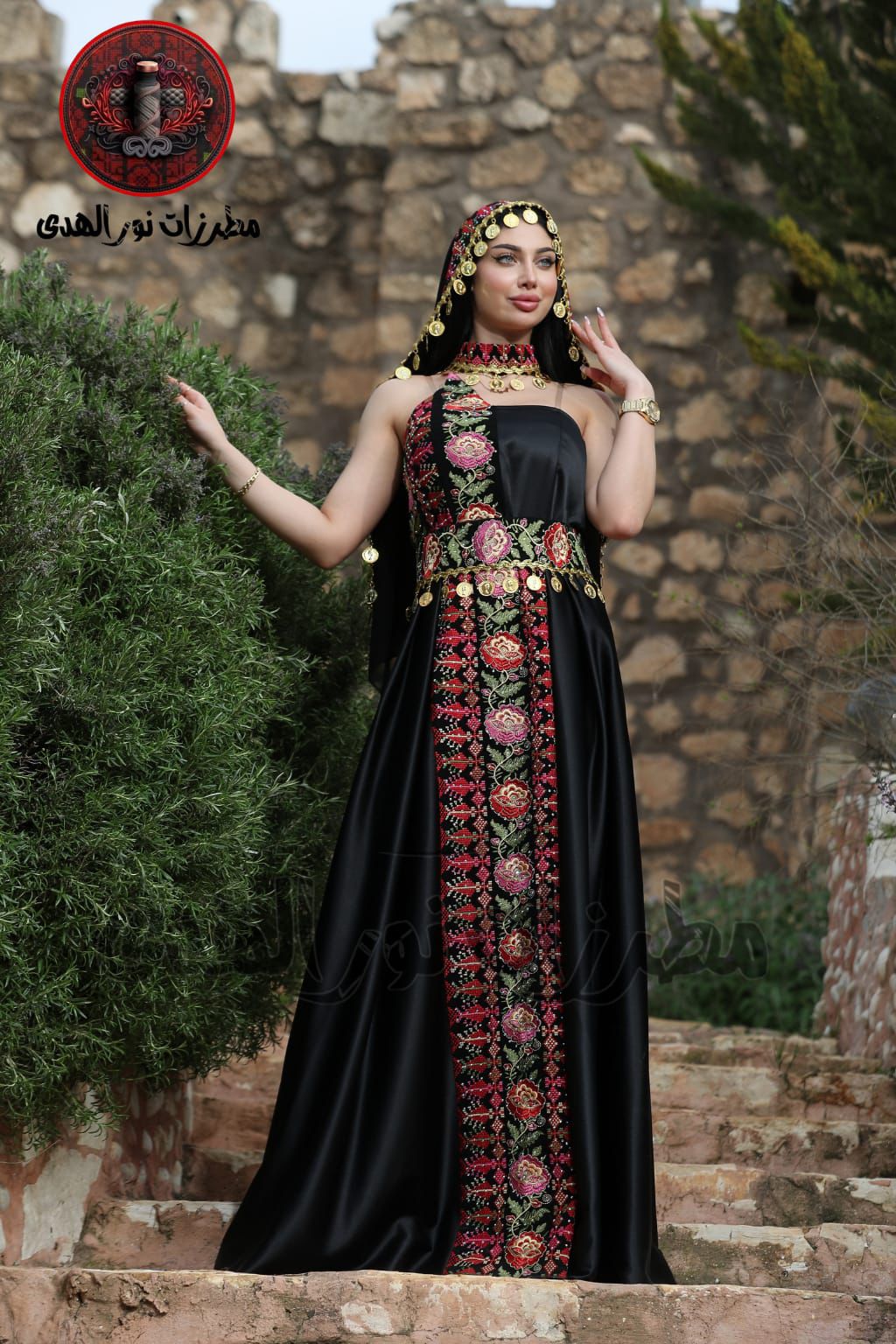 Black satin Palestinian embroidered henna dress with floral front embroidery, gold coin details, and heritage styling