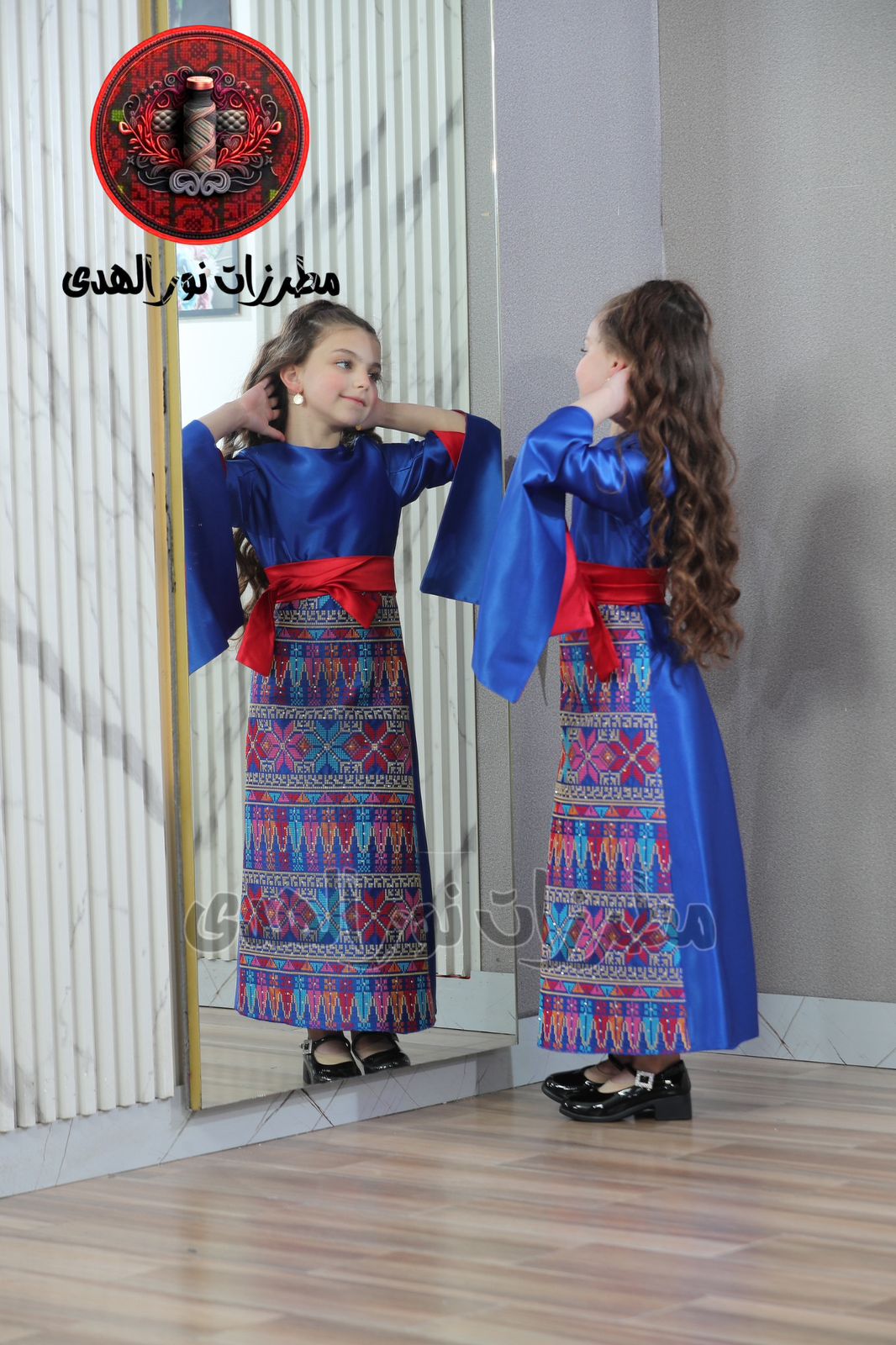 Indigo blue girls Oriental embroidered satin heritage dress with red sash and colorful Tatreez-inspired skirt panel