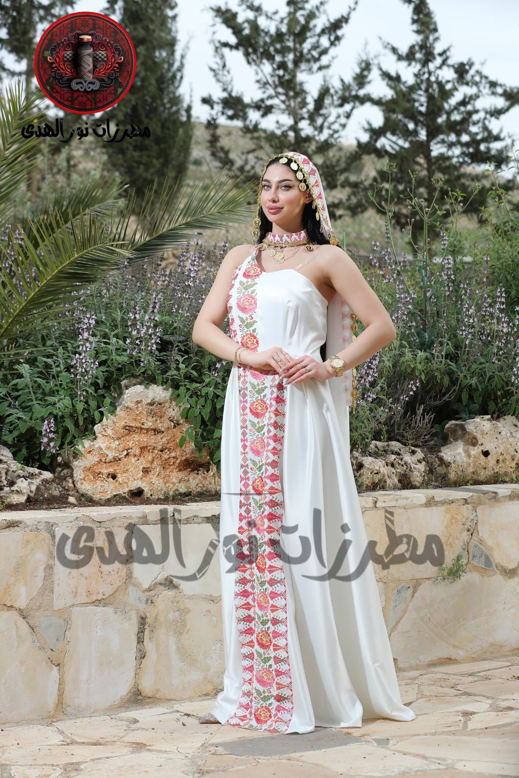 White satin embroidered henna dress with pink floral Tatreez-inspired front panel and matching draped accessory