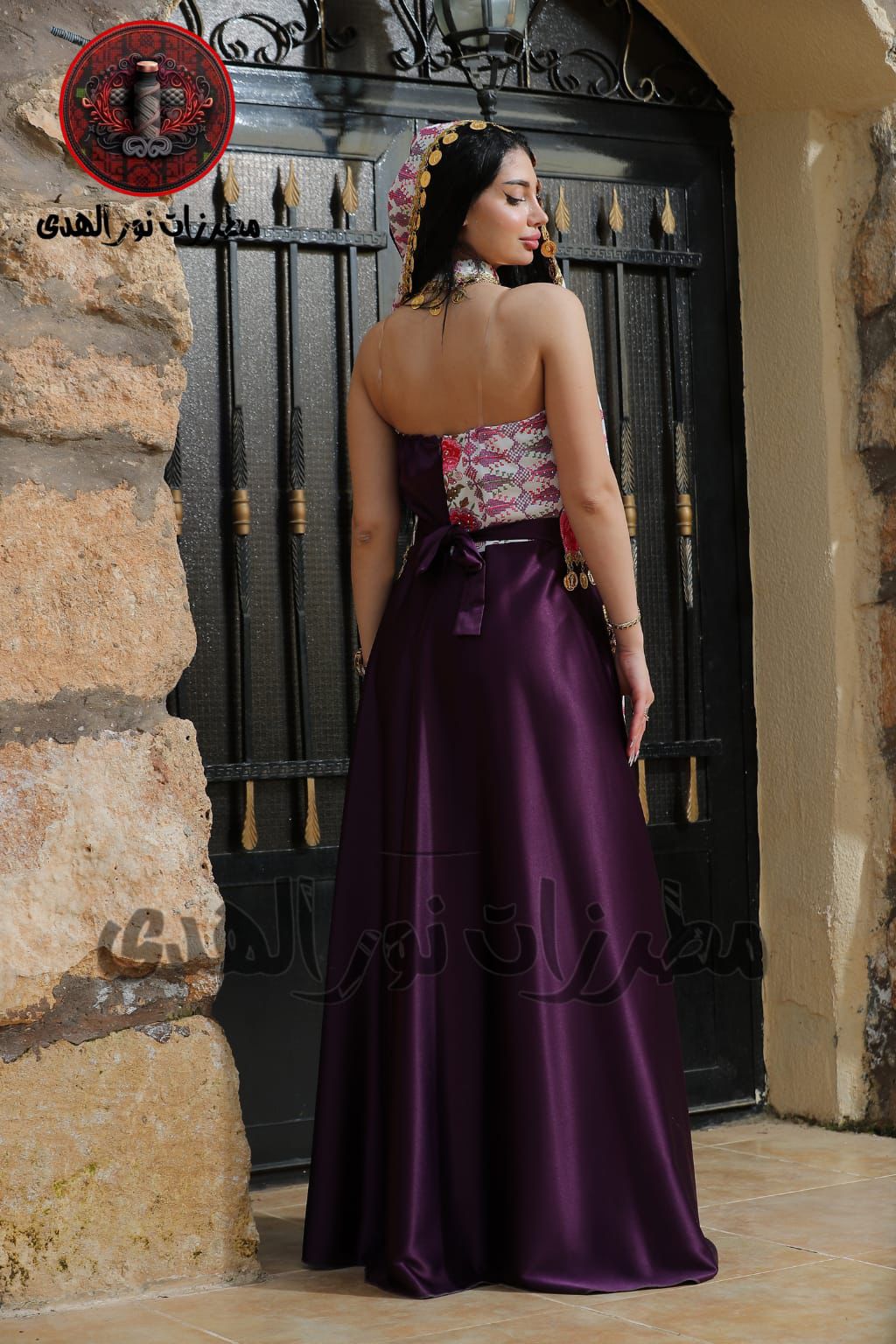 Back view of mauve pink satin henna dress with matching tie waist and draped embroidered accessory