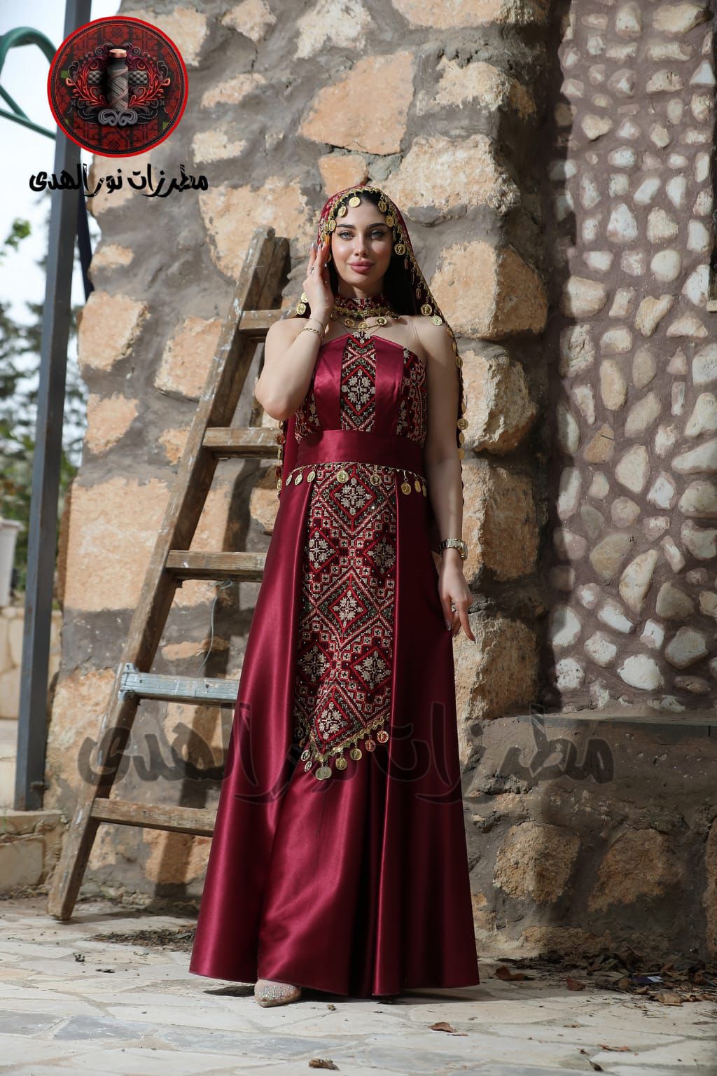 Burgundy embroidered henna dress with traditional coin accents, matching belt, and heritage-inspired front panel