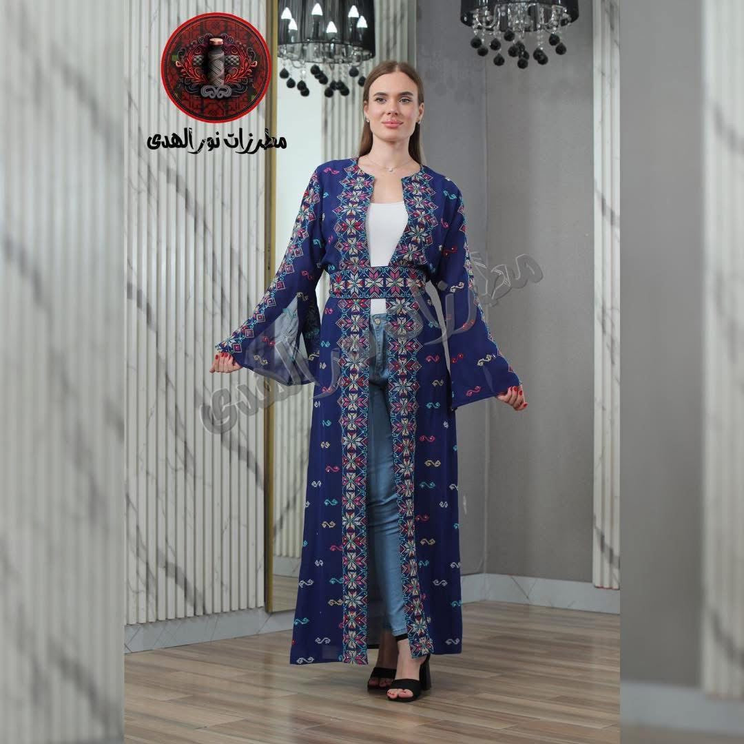 Navy blue embroidered women’s bisht styled over jeans with colorful Levant-style motifs