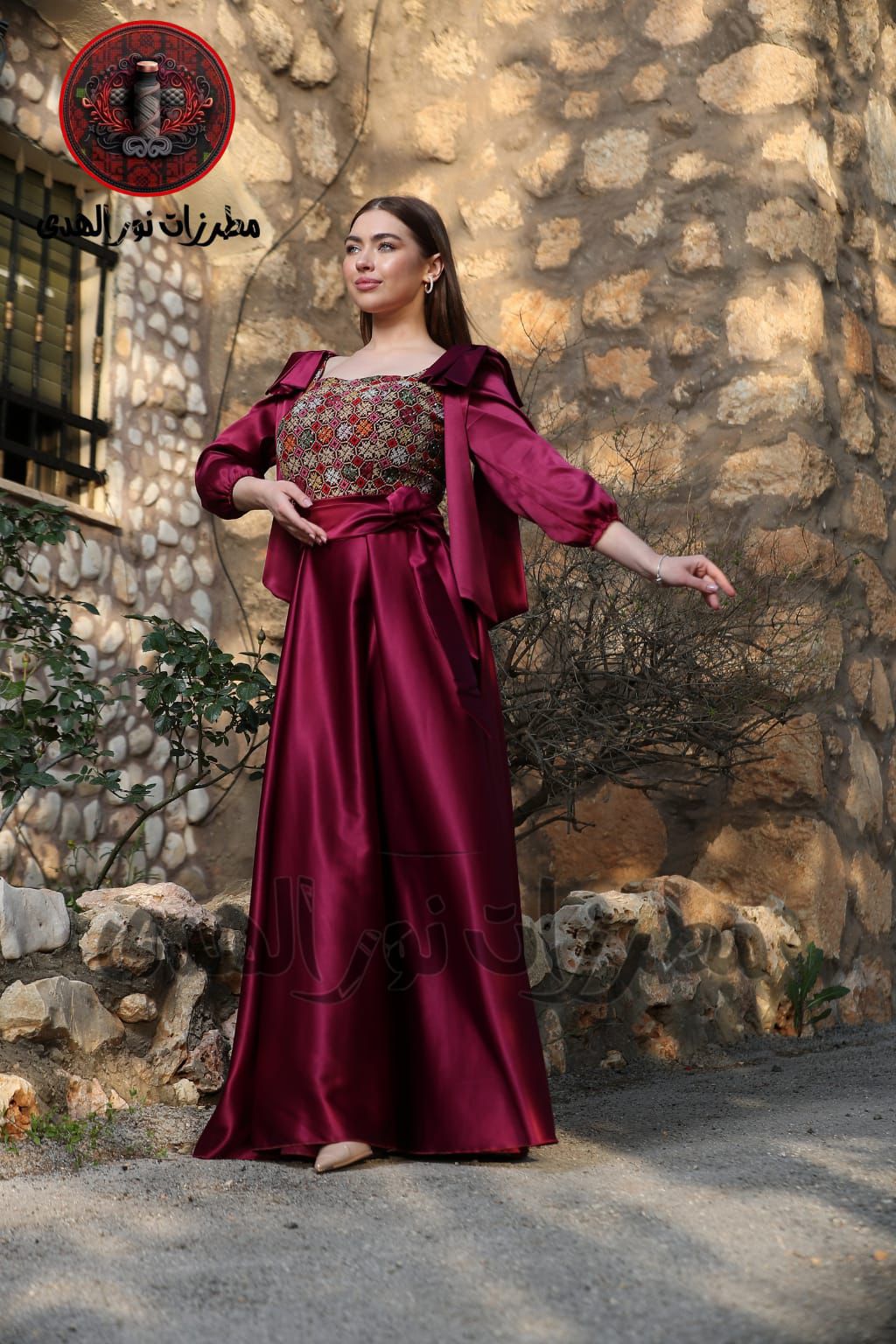 Burgundy long satin Oriental embroidered heritage dress with fitted Tatreez-inspired bodice and flowing silhouette