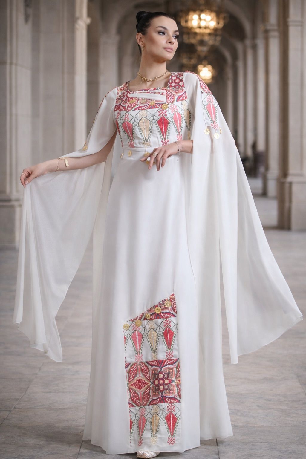 White chiffon lined Palestinian embroidered thobe with square neckline, gold coin details, and flowing cape-style sleeves, ثوب فلسطيني أبيض من الشيفون المبطن مع فتحة رقبة مربعة وتطريز ملون وتفاصيل عملات ذهبية وأكمام كاب منسدلة