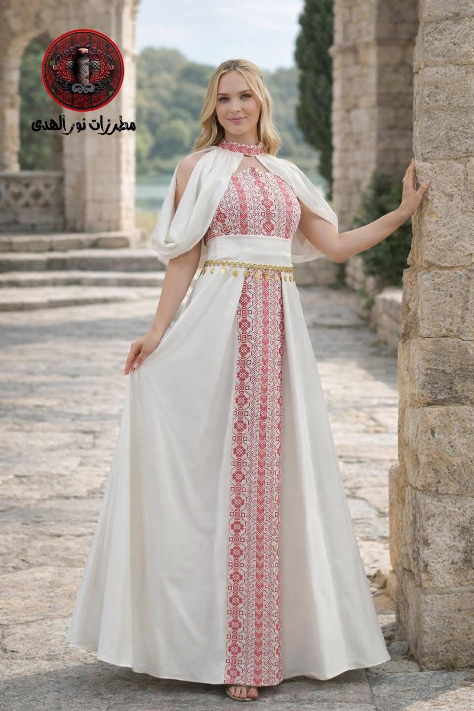 White Palestinian embroidered henna dress with pink Tatreez-inspired front panel, cape sleeves, and gold coin details