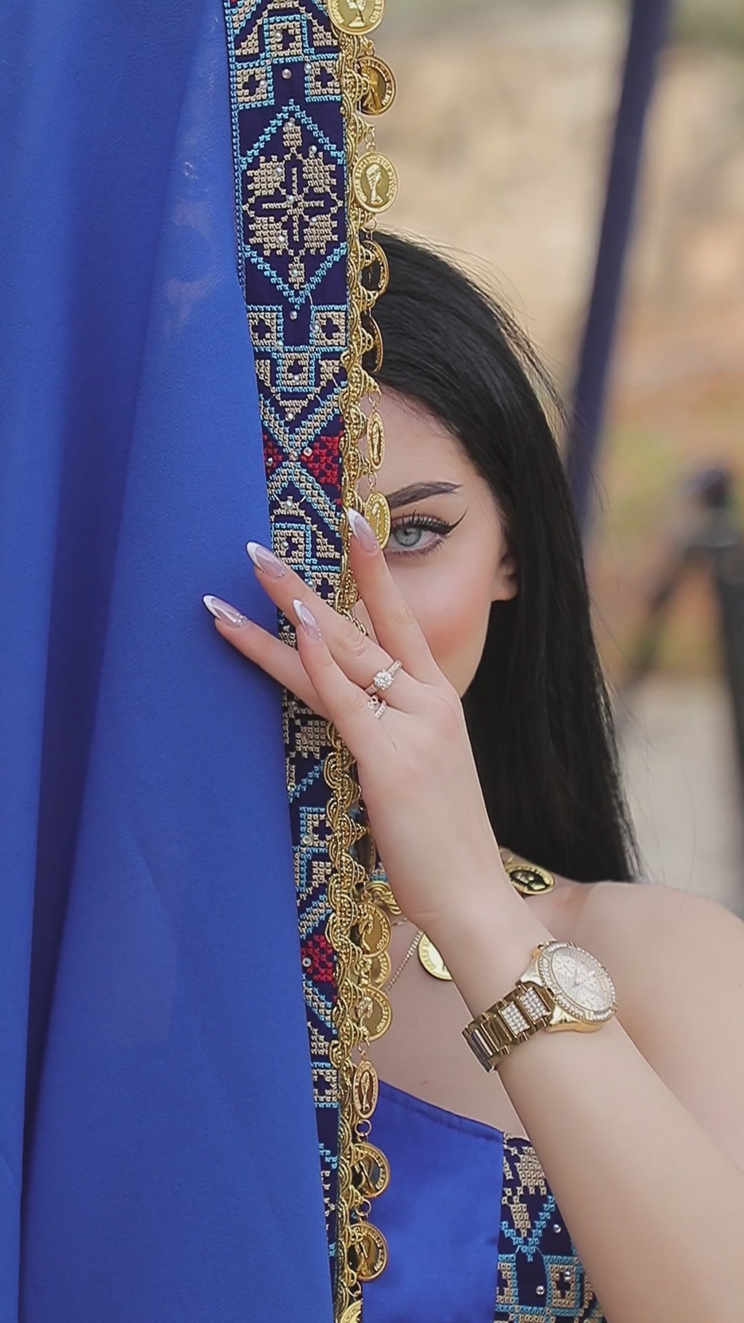 Berry purple Jawharat Al-Henna Dress with Palestinian Tatreez-inspired embroidery, draped head cover, and gold coin details