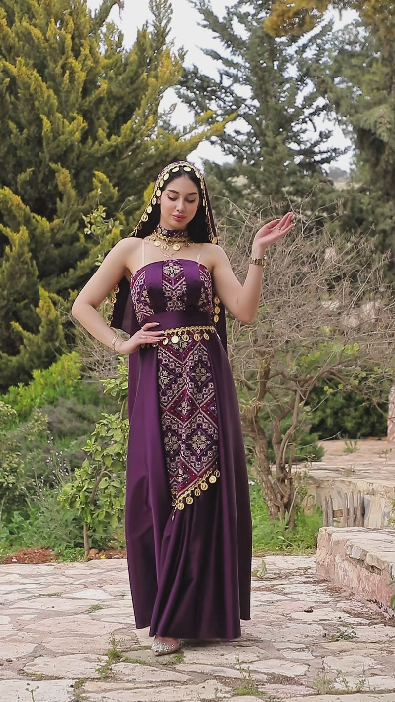 Berry purple Jawharat Al-Henna Dress with Palestinian Tatreez-inspired embroidery, draped head cover, and gold coin details